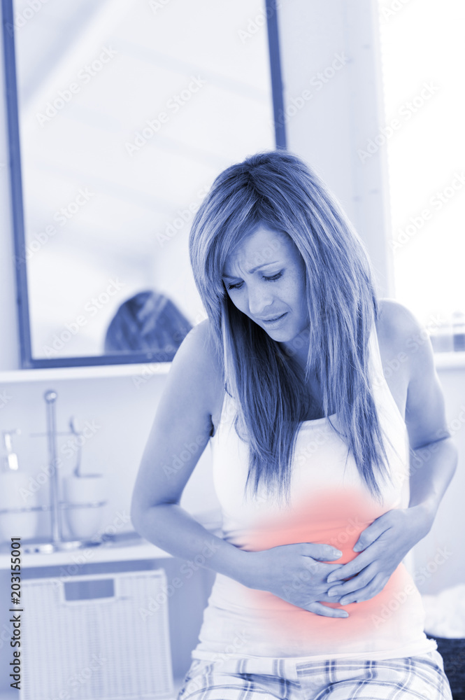 Suffering woman having a stomachache in her bathroom at home Suffering woman having a stomachache in her bathroom at home