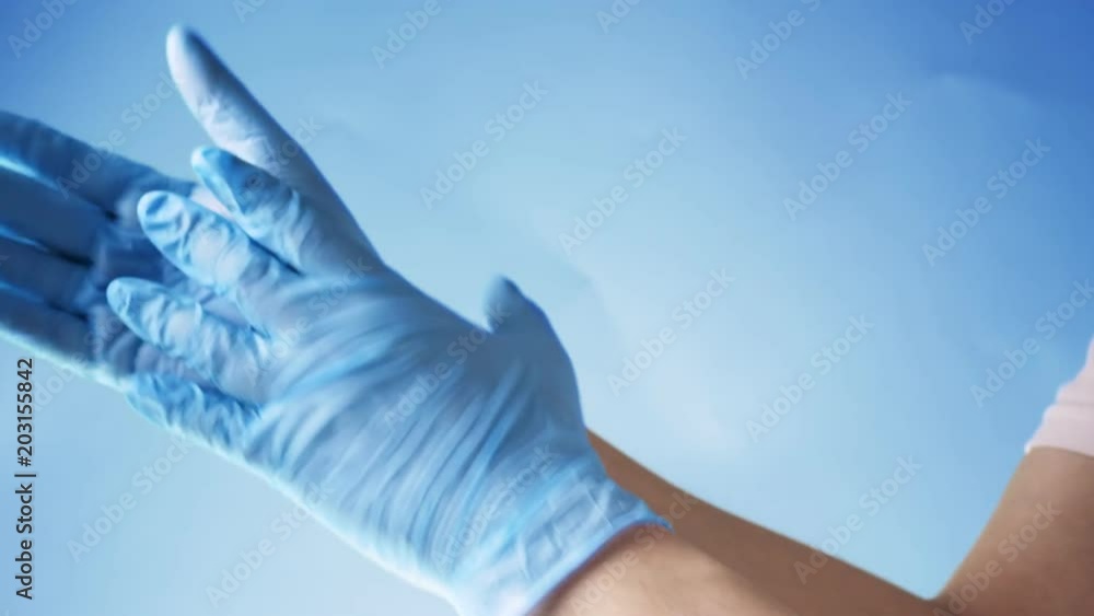 Doctor take off blue latex gloves Doctor take off blue latex gloves