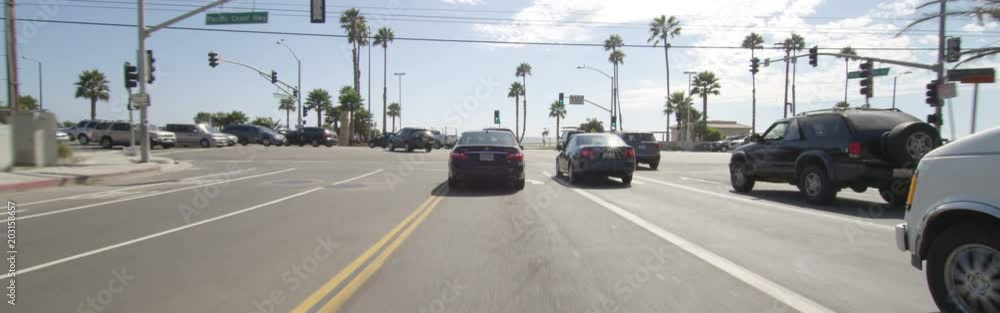 Front view of a Driving Plate: Car traveling on Temescal Canyon Road in Santa Monica, California, turns left onto Pacific Coast Highway and continues south. Front view of a Driving Plate: Car traveling on Temescal Canyon Road in Santa Monica, California, turns left onto Pacific Coast Highway and continues south.