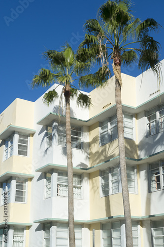 Typical pastel-colorfed 1930s Art Deco architecture with palm trees in Miami, Florida © lazyllama