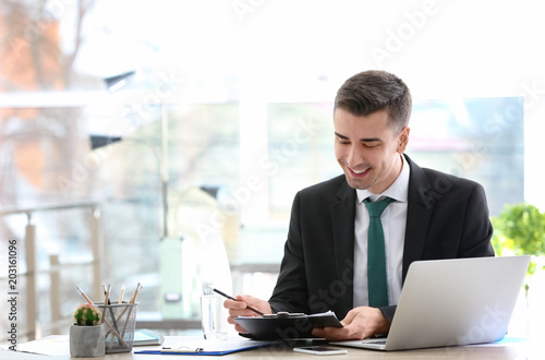 Consultant working at table in office