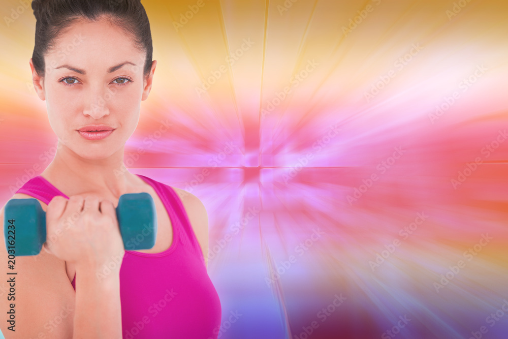 Fit woman lifting blue dumbbell against abstract background Fit woman lifting blue dumbbell against abstract background