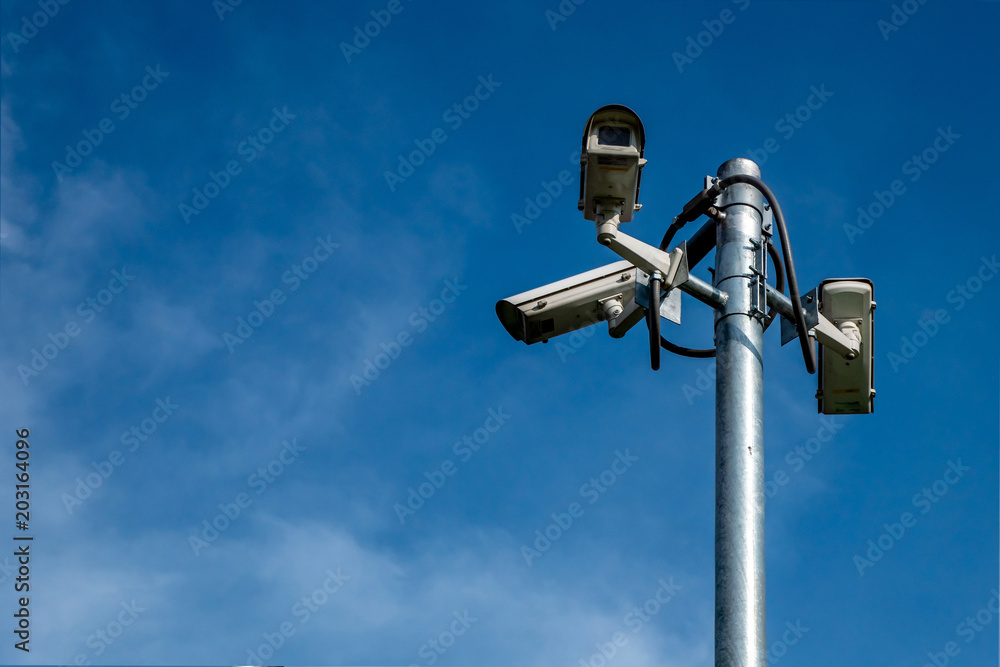 CCTV or VDO camera for traffic at the outside of building with the blue sky in the sunny day. CCTV or VDO camera for traffic at the outside of building with the blue sky in the sunny day.