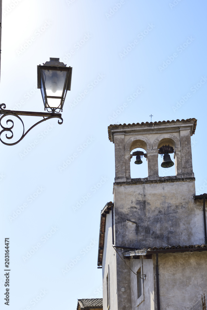 bell tower of an old church in an alley of Orvieto, Italy