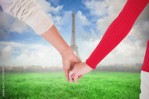 Couple holding hands rear view against eiffel tower © vectorfusionart