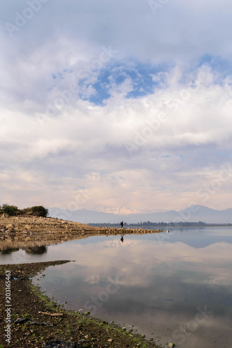 Lonesome fisherman traveler being reflected in Convento Viejo Dam  VI Region near Chimbarongo  Chile