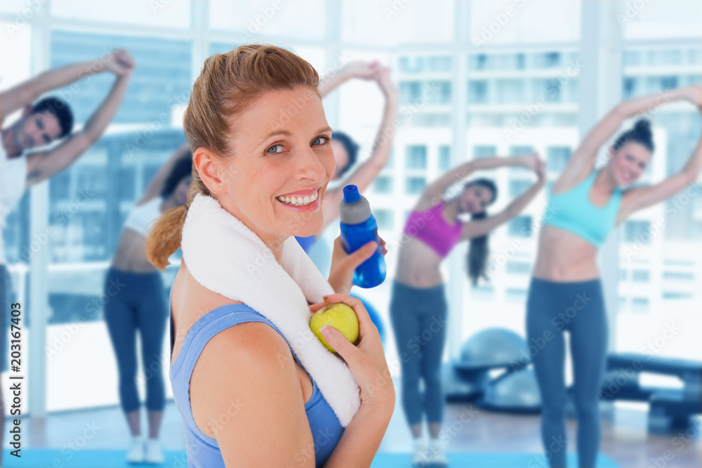 Composite image of fit woman smiling at camera Composite image of fit woman smiling at camera