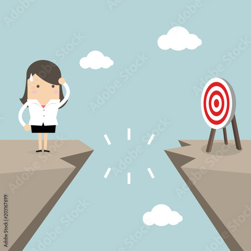 Businesswoman in front of a gap and looking into the empty space underneath.
