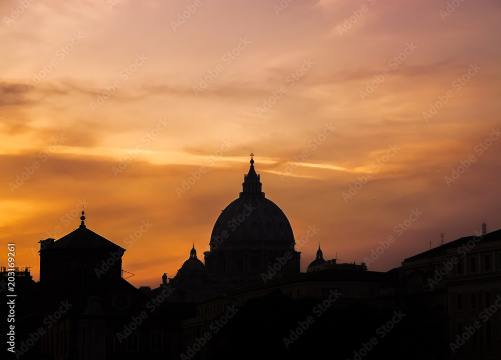 Silhouette of city buildings on sunset sky
