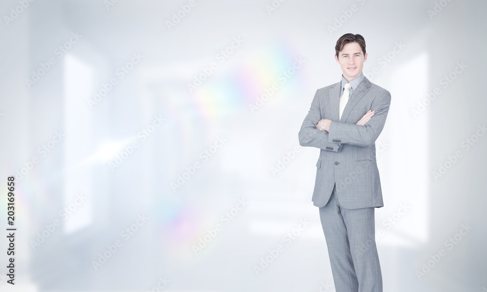 Assertive businessman standing against digitally generated room Assertive businessman standing against digitally generated room