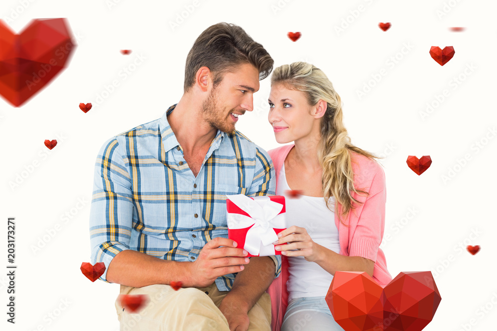 Couple with gift against hearts Couple with gift against hearts