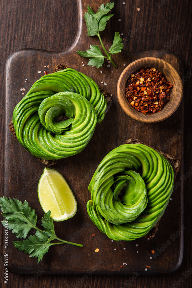 toast with avocado roses on wooden cutting board