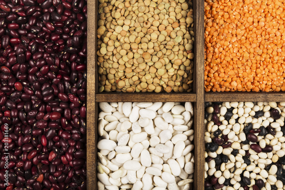Assortment of beans (red lentil, green lentil, chickpea, peas, red beans, white beans, mix beans, mung bean). Top view. Food background Assortment of beans (red lentil, green lentil, chickpea, peas, red beans, white beans, mix beans, mung bean). Top view. Food background
