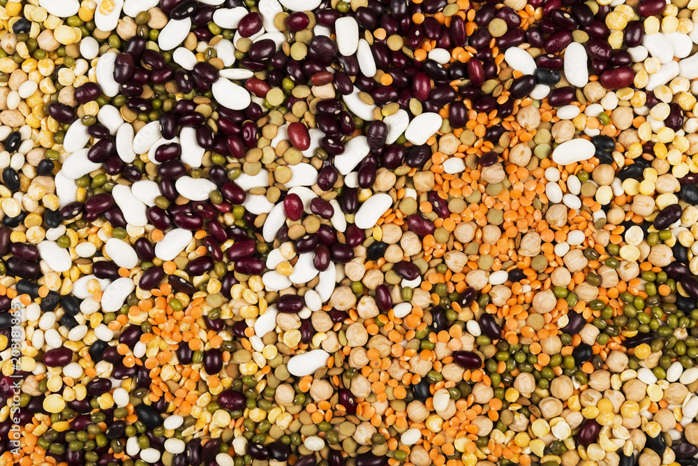 Assortment of beans (red lentil, green lentil, chickpea, peas, red beans, white beans, mix beans, mung bean) on gray background. Top view. Food background Assortment of beans (red lentil, green lentil, chickpea, peas, red beans, white beans, mix beans, mung bean) on gray background. Top view. Food background