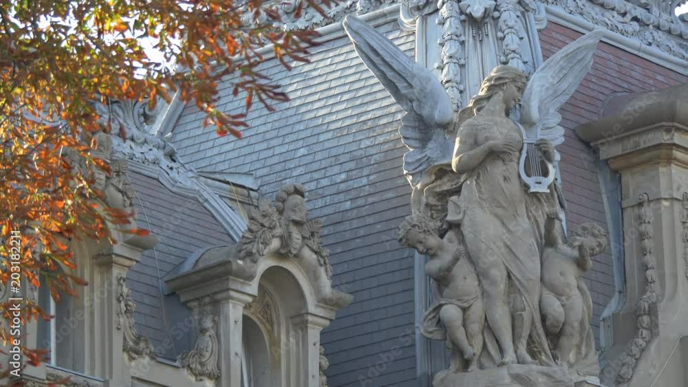 Statue of an angel with harp and two children Statue of an angel with harp and two children