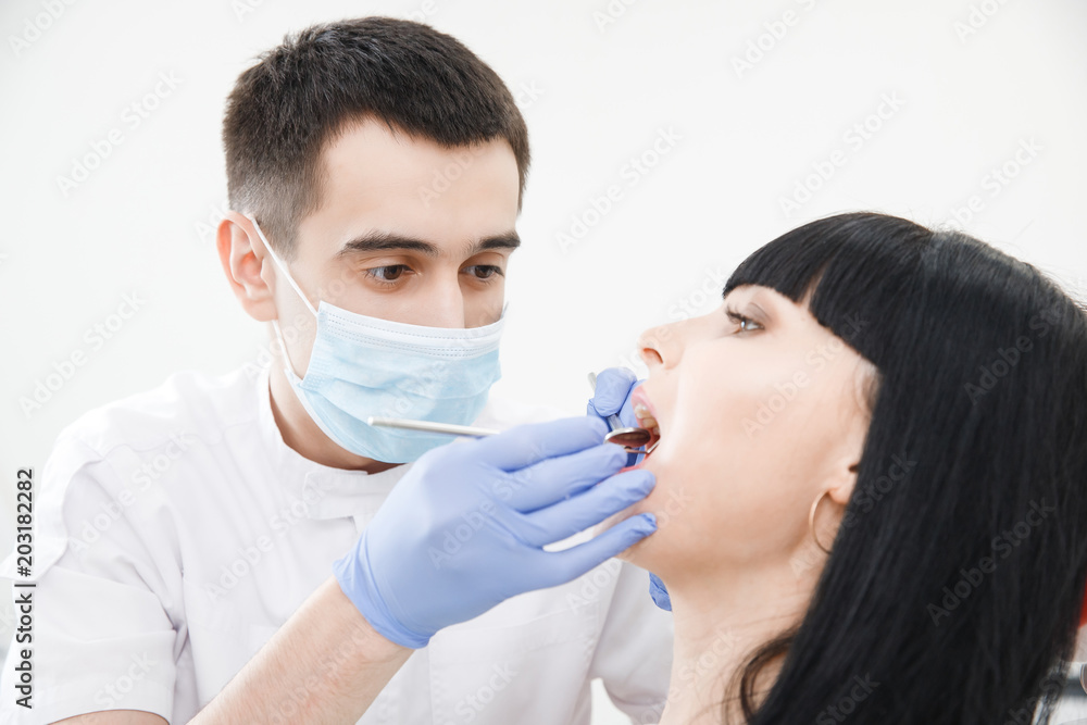Young woman at reception and examination of teeth by male dentist. Medical Clinic. Young woman at reception and examination of teeth by male dentist. Medical Clinic.