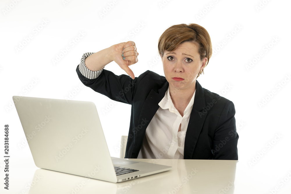 Attractive young business woman working on her computer stressed, tired and overwhelmed. Attractive young business woman working on her computer stressed, tired and overwhelmed.