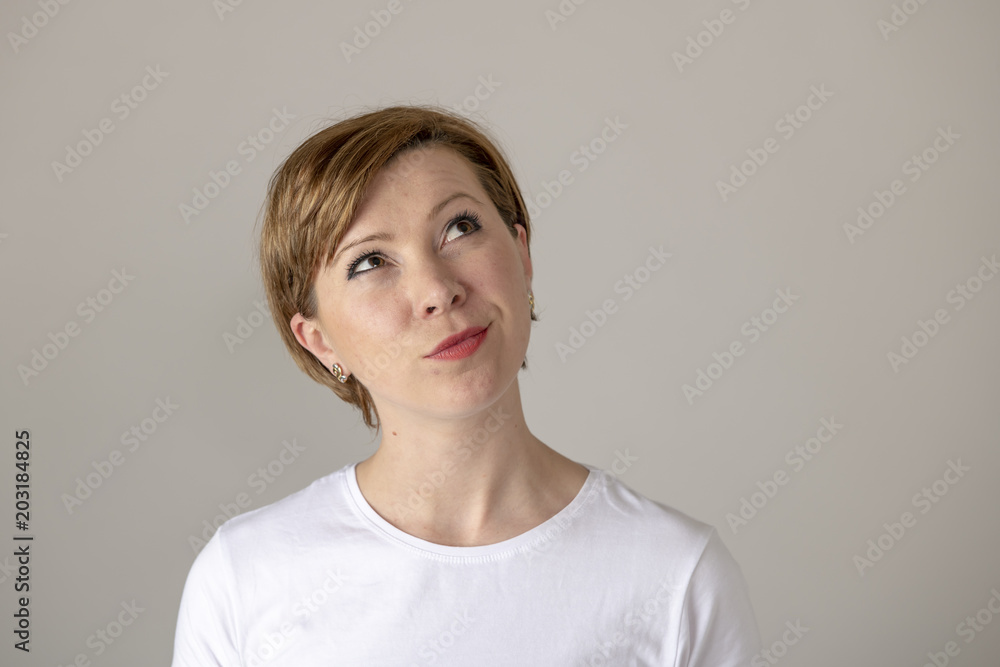 human expressions and emotions. young attractive woman with a thinking and looking up wondering. human expressions and emotions. young attractive woman with a thinking and looking up wondering.