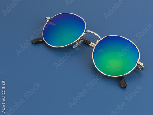 blue sunglasses on a blue background. 