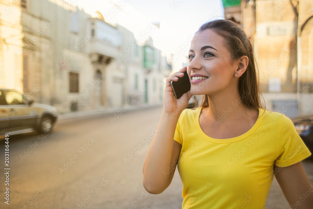 Cheerful girl using a smartphone Cheerful girl using a smartphone