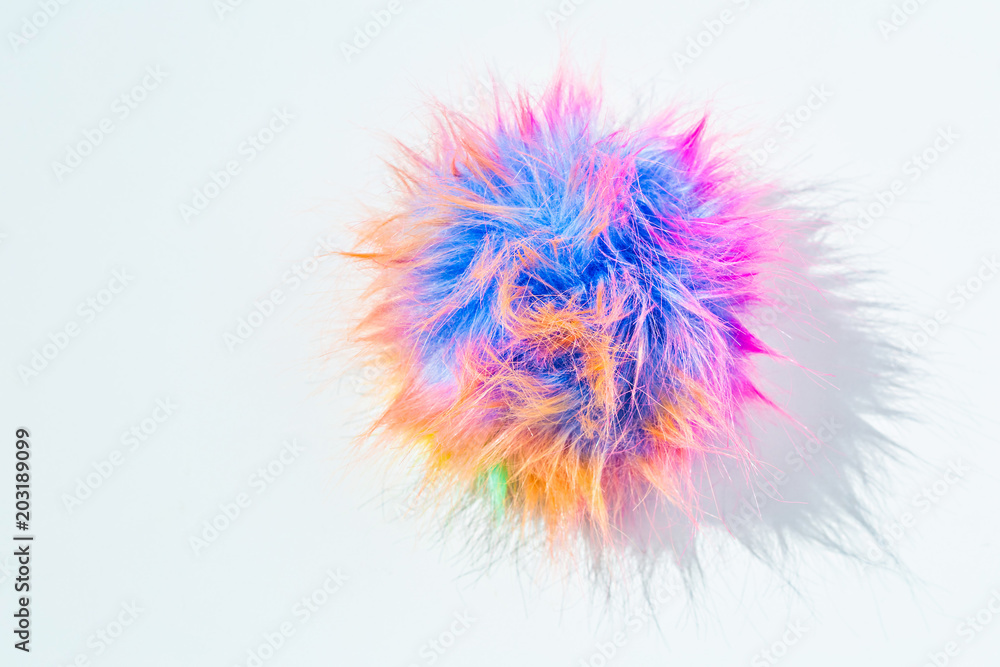 Funny colorful rainbow colors pom-pom. The challenge of everyday life and gray shades. Bright colors of life and joy concept