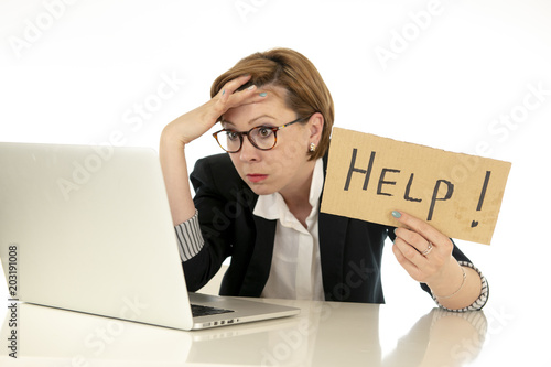 Attractive young overwhelmed and frustrated business woman working on her computer asking for help photo