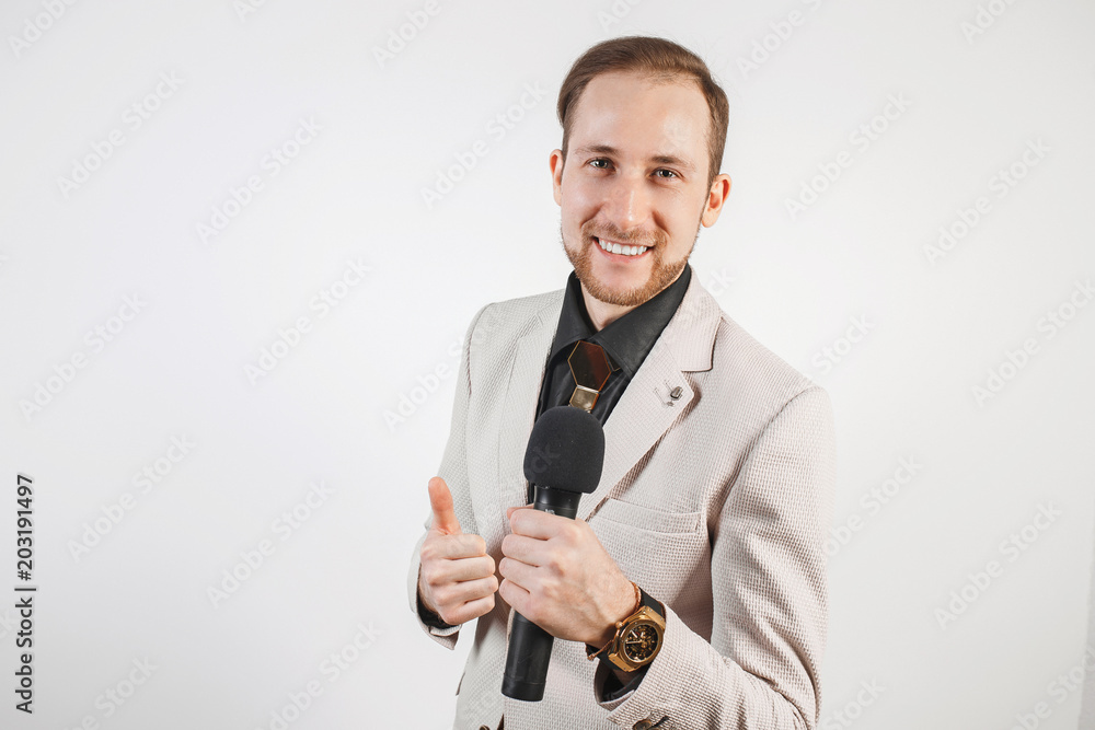 Young man with microphone on white background, leading with microphone Young man with microphone on white background, leading with microphone