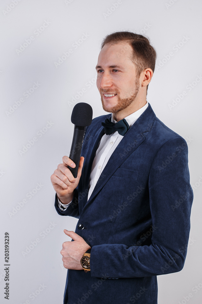 Young man with microphone on white background, leading with microphone Young man with microphone on white background, leading with microphone