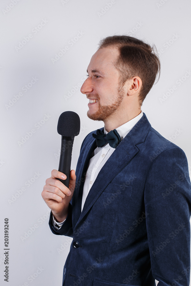 Young man with microphone on white background, leading with microphone Young man with microphone on white background, leading with microphone