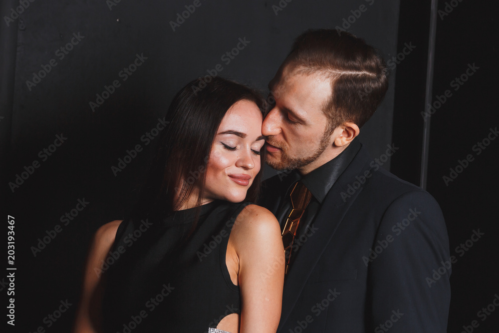 guy and girl in love posing on a black background guy and girl in love posing on a black background