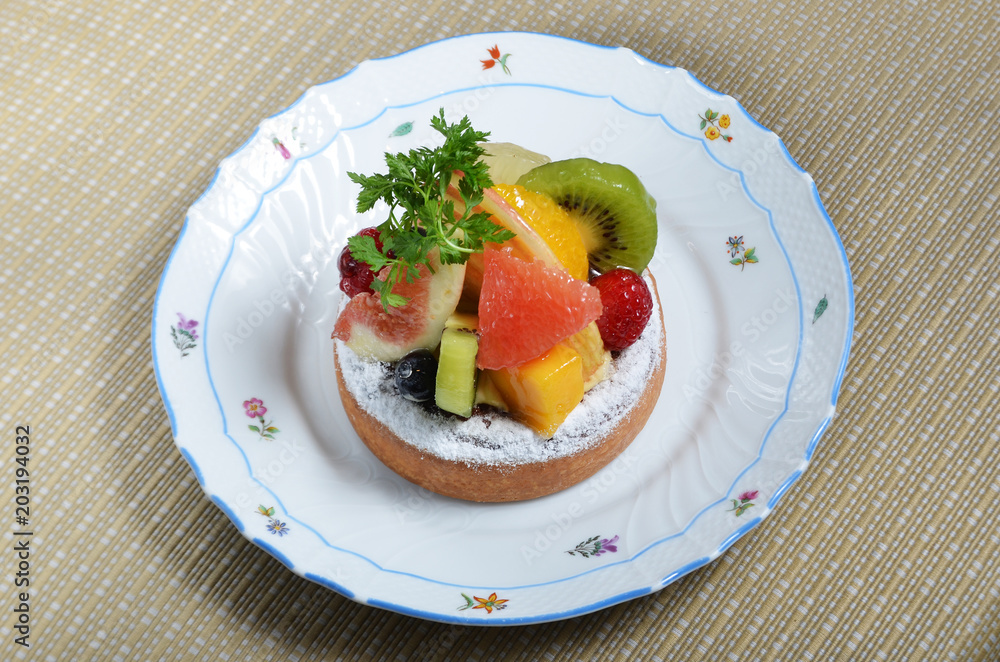 Fresh fruit tart with kiwi, apple, mango, orange and strawberry. Fresh fruit tart with kiwi, apple, mango, orange and strawberry.