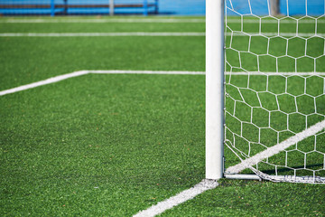 Goal post on football field with artificial lawn