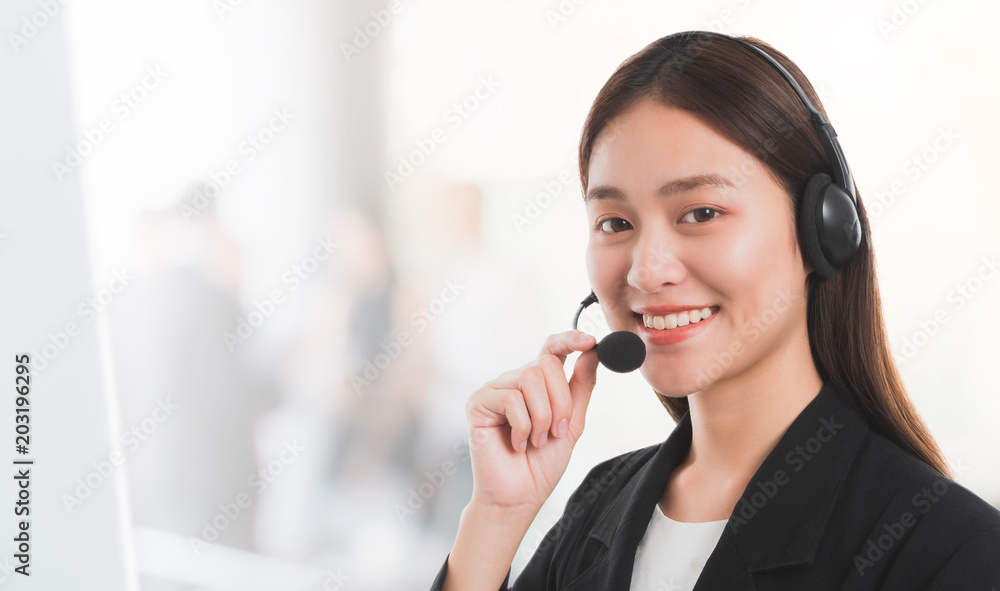 Portrait of Asian beautiful smiling woman customer support phone operator in office space background and copy space.Concept call center job service. Portrait of Asian beautiful smiling woman customer support phone operator in office space background and copy space.Concept call center job service.