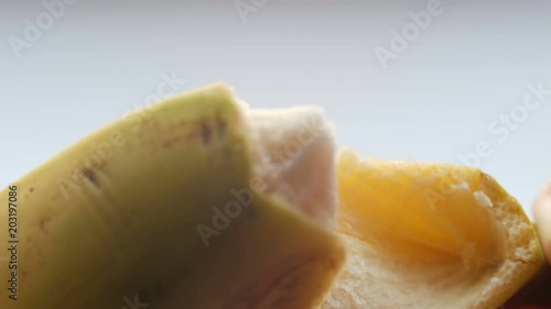 Woman sexually peel banana skin, macro close up view