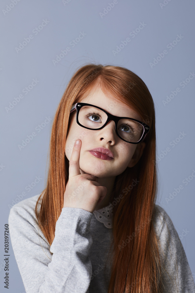Redheaded glasses girl in thought
