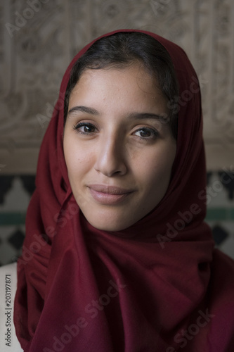 Portrait of young muslim woman smiling with red hijab headscarf