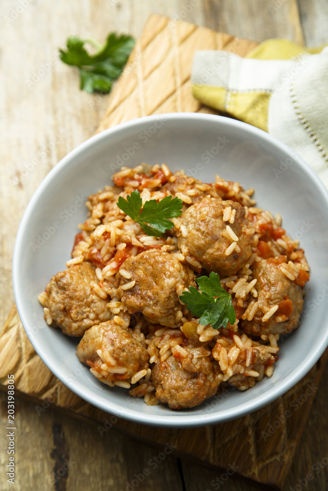 Homemade meatballs with rice, tomato and fresh parsley