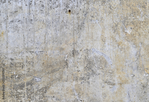 Part of the concrete wall with loose plaster of the old building. Background