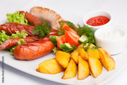 beautiful photo close-up menu of potatoes, sausage salad on a plate on a white background