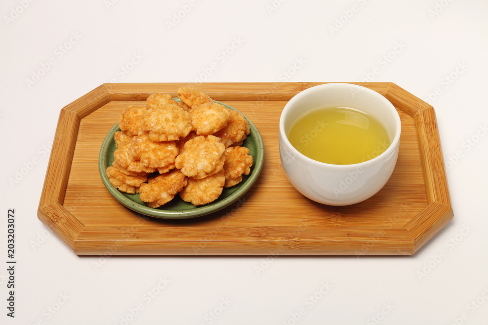 Japanese senbei and green tea on a tray, Japanese senbei and green tea on a tray,