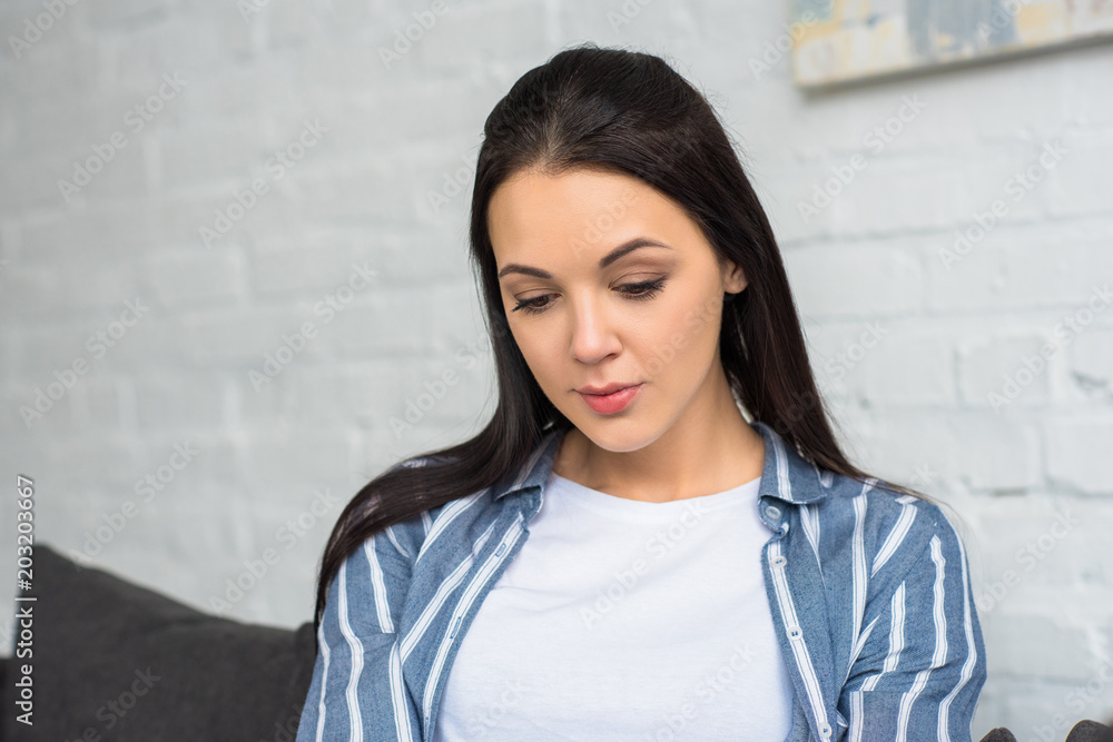 portrait of young woman looking away at home portrait of young woman looking away at home