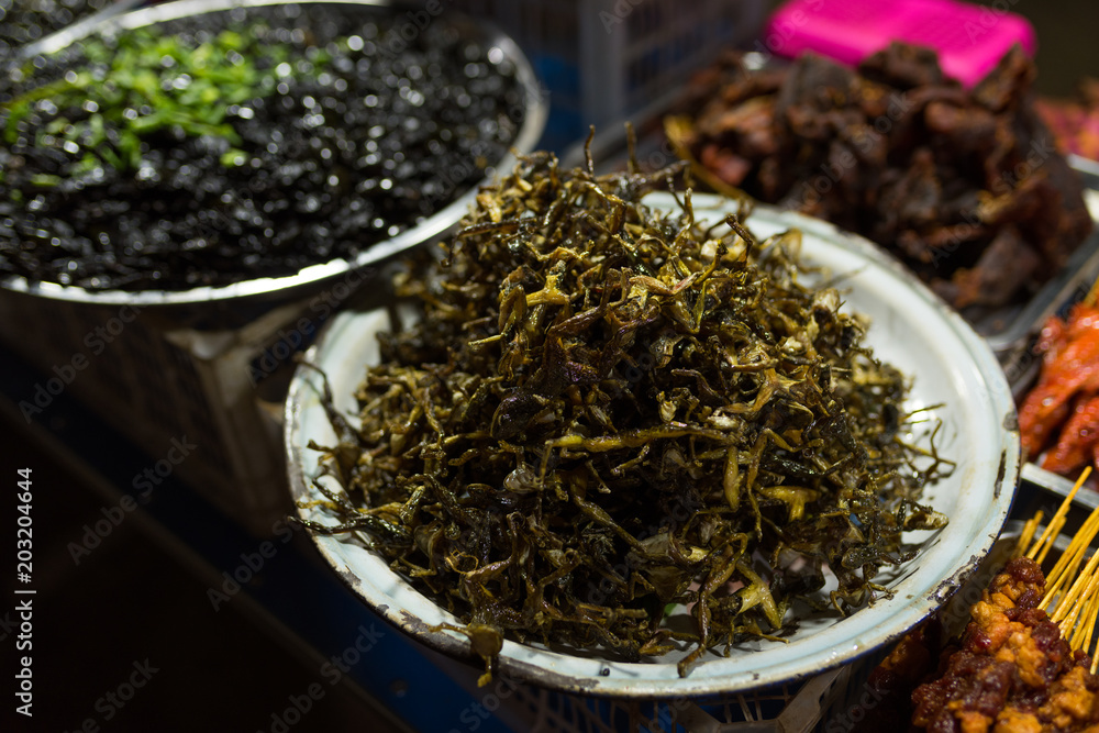 Cambodian night street food market with dried and grilled frog Cambodian night street food market with dried and grilled frog