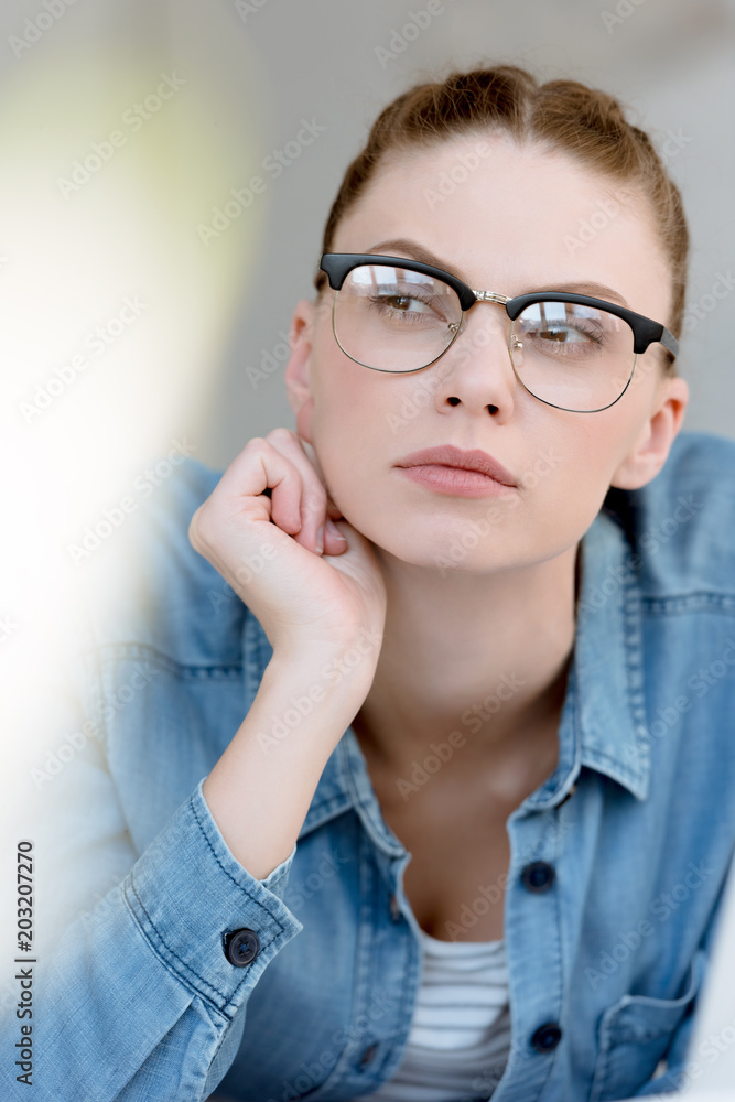 portrait of thoughtful young woman in eyeglasses portrait of thoughtful young woman in eyeglasses