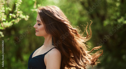 The beautiful girl stands in the park