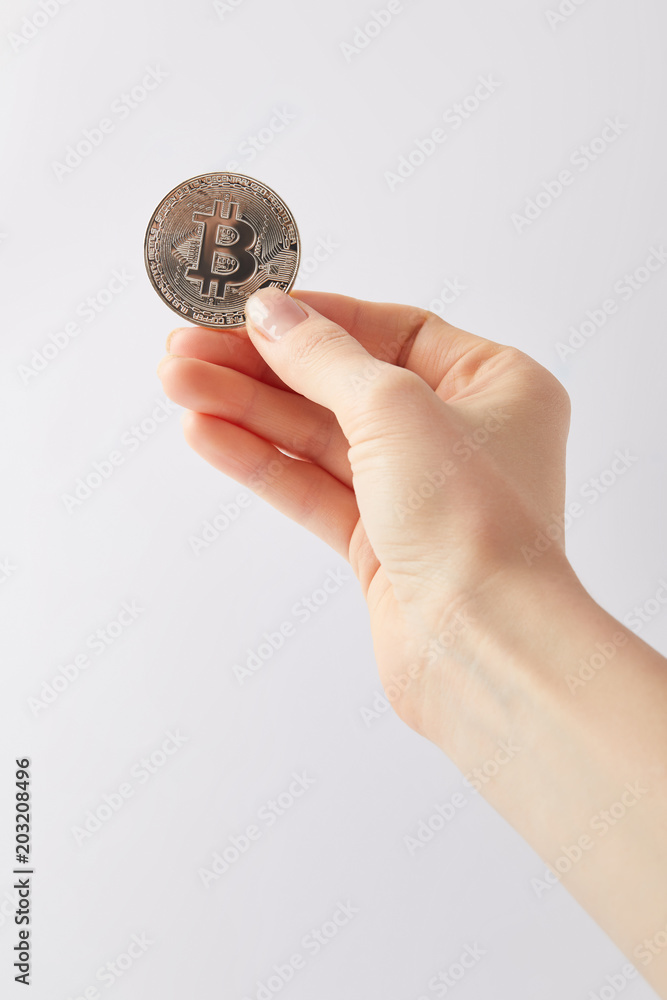 cropped shot of woman holding silver bitcoin isolated on white cropped shot of woman holding silver bitcoin isolated on white