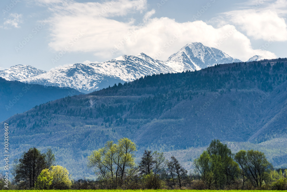 Fresh spring morning with Carpathian mountains in the background covered in snow