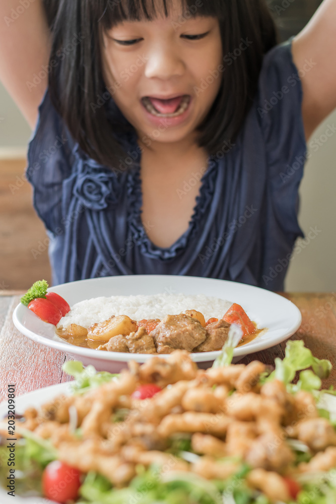 Child appetite concept with happy Asian school kid with delicious nutritional meal of food menu for breakfast, lunch, or dinner served with beautiful decoration on kitchen table