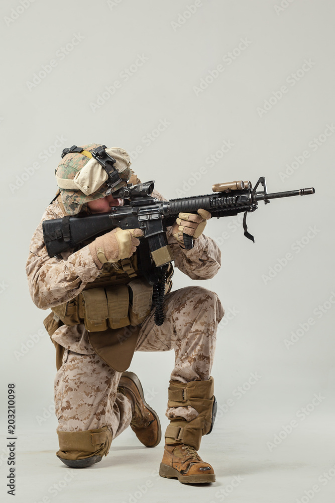 Soldier in camouflage holding rifle Soldier in camouflage holding rifle