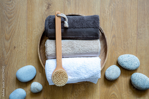 rolled up towels and body dry brush for male exfoliation