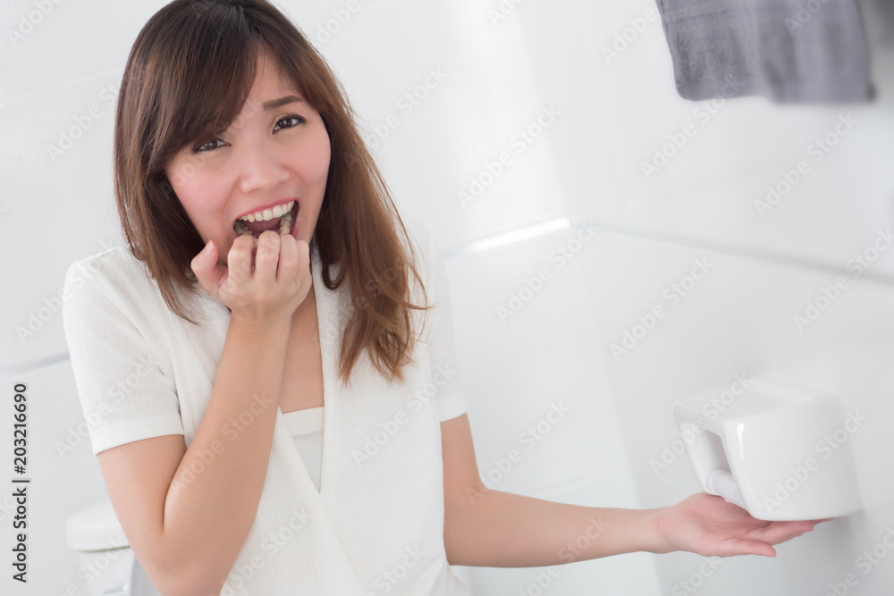 screaming woman with no toilet paper in restroom; portrait of asian woman finding no toilet paper left in the bathroom or wc, concept of crisis, trouble, problem; asian young adult woman model screaming woman with no toilet paper in restroom; portrait of asian woman finding no toilet paper left in the bathroom or wc, concept of crisis, trouble, problem; asian young adult woman model